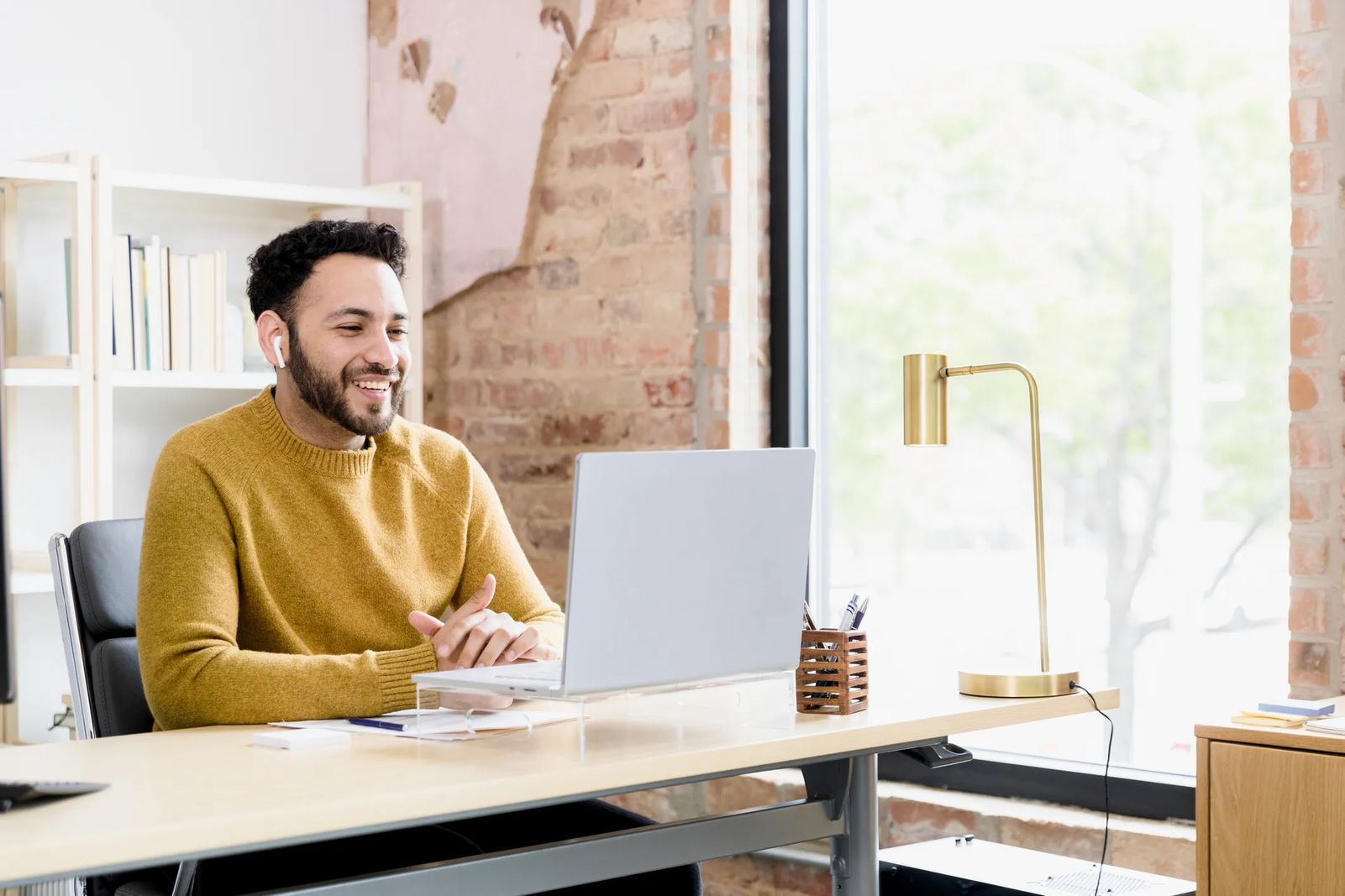 man coaching over video on computer, small business life coaching operator