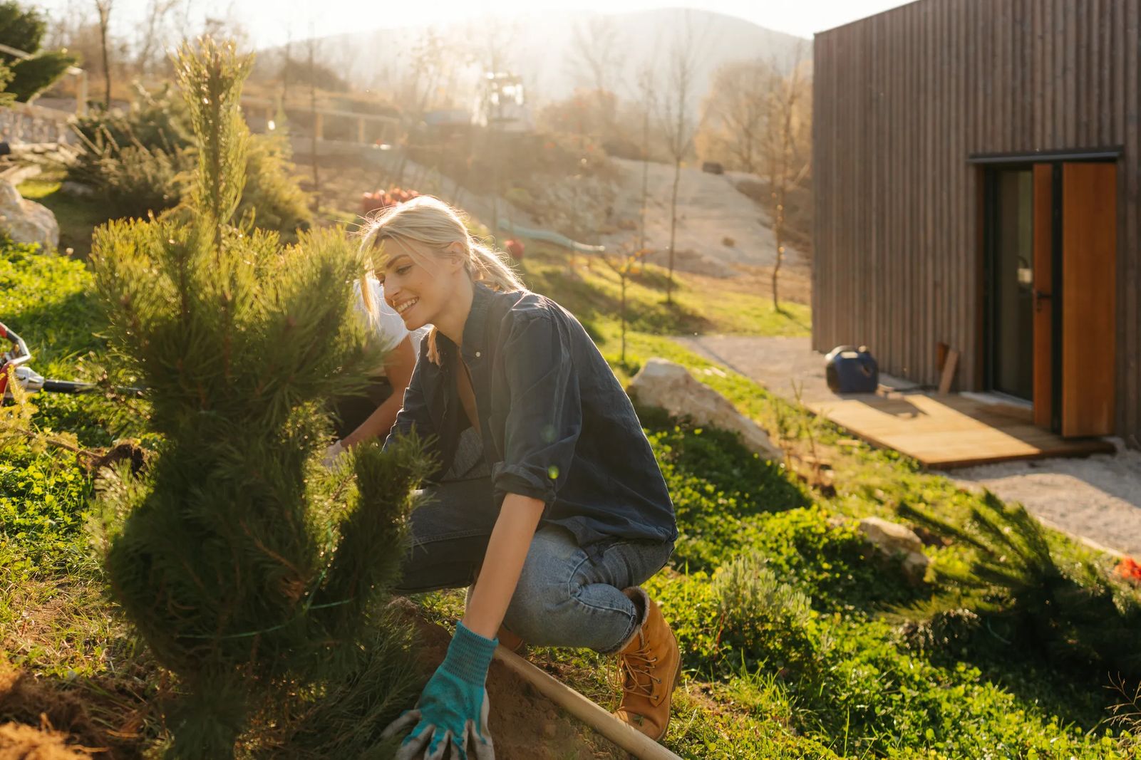 website goals example - landscaping business owner woman planting tree