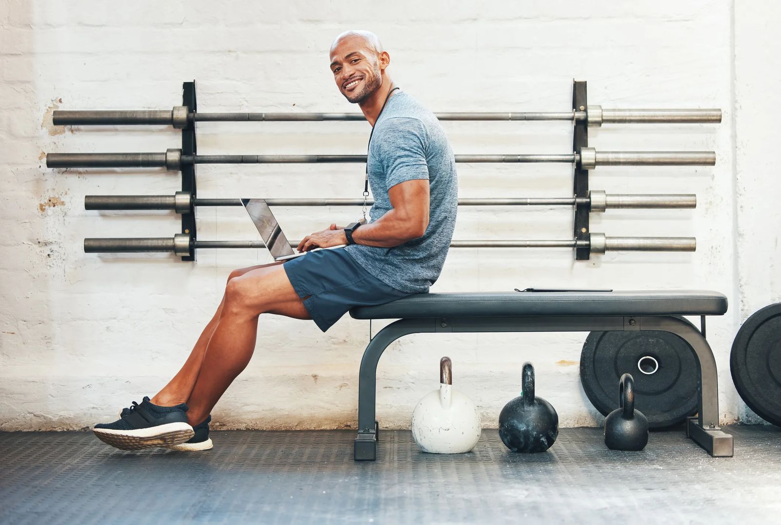 set website goals example - image of man on workout bench with computer